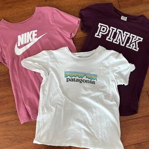Group of T shirts. Pink and Patagonia size XS and Nike is size Small